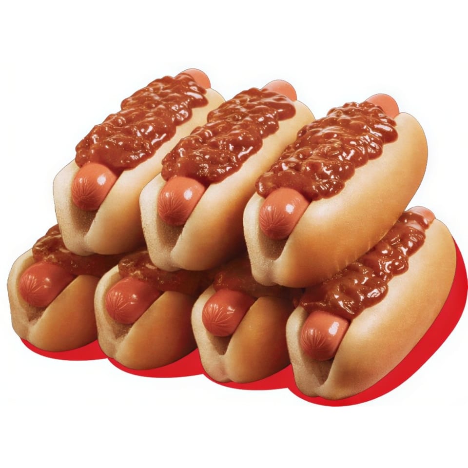 A stack of six chili dogs with red hot dogs and thick chili sauce on white buns.